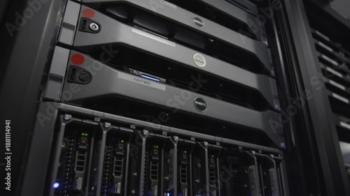 Close-up of a Dell server with multiple hard drives in a dark data center with a focus on computer hardware