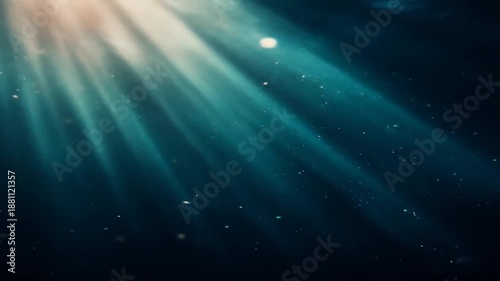 Underwater sunlight beams shining through dark blue water background
