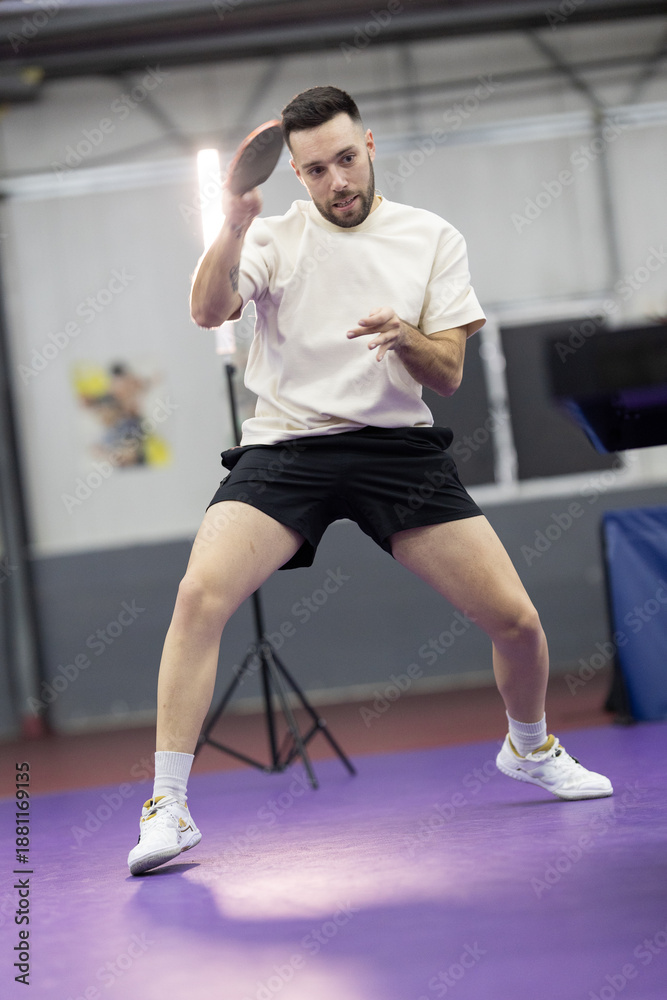 Fototapeta premium Young man playing table tennis at training session