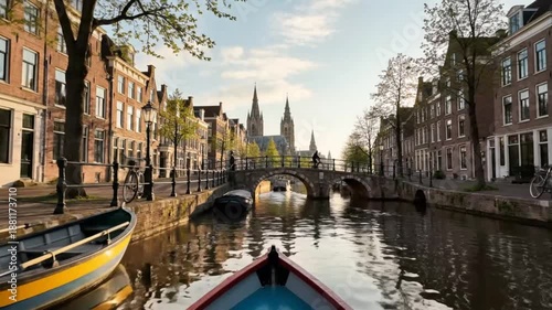 Scenic canal boat tour passing historic buildings and bridges in the Dutch city of Haarlem on a sunny day