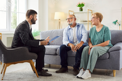 Cuadro en lienzo Senior couple meets an advisor on couch at home for private consultation about care, finances and emotional support