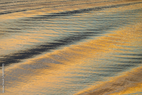 Abstract water surface reflecting golden sunlight, Algarve, Portugal