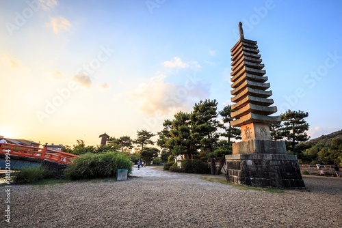 Thirteen-Story Stone Pagoda and Red Bridge at Sunset in Uji