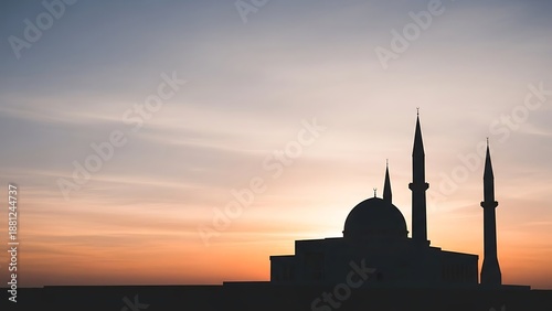 Mosque silhouette against a serene sunset sky with warm colors, symbolizing peace and spirituality.