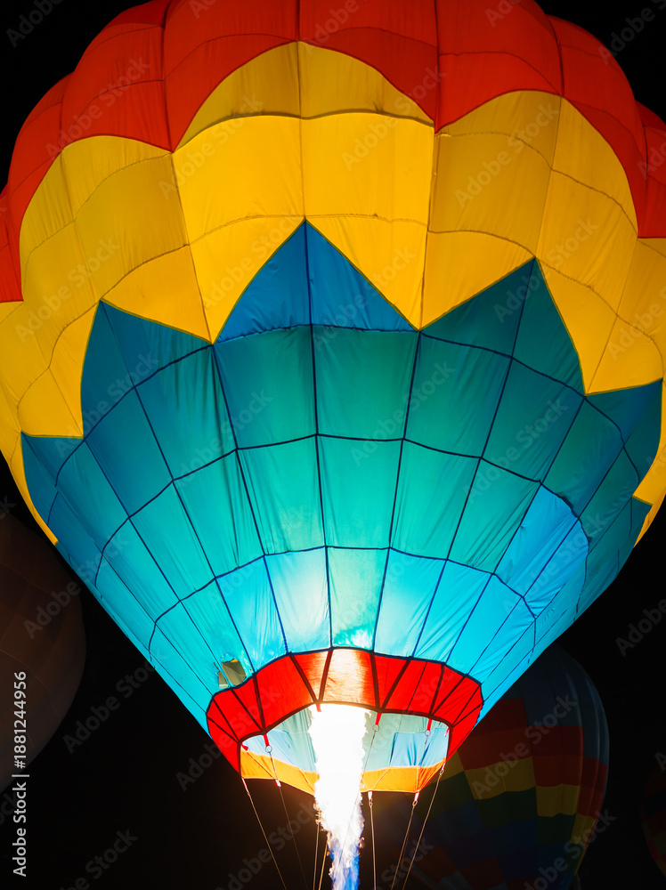 Obraz premium colorful hot air balloons glowing against dark night sky