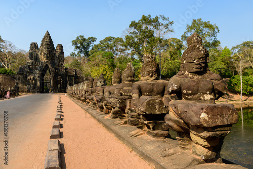Фотография Rows of massive stone guardian figures line the bridge leading to the monumental south gate of Angkor Thom near Siem Reap, Cambodia