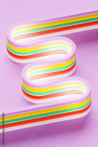 An abstract pattern featuring vibrant, intersecting lines arranged in a dynamic crossing design. The lines are colorful and set against a light background