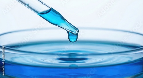 Wallpaper Mural Pipette dropping blue liquid into glassware creating ripples Torontodigital.ca