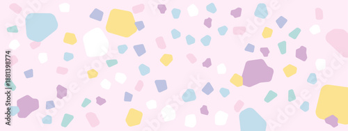 Abstract seamless pattern of colorful stone chips or terrazzo fragments scattered on a soft pink background