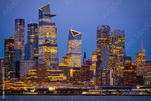 Photography . New York City skyline over river. New York City illuminated buildings. New Yor