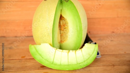 Closeup to Fresh green melon on wood plate