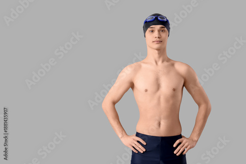 Young male swimmer on light...