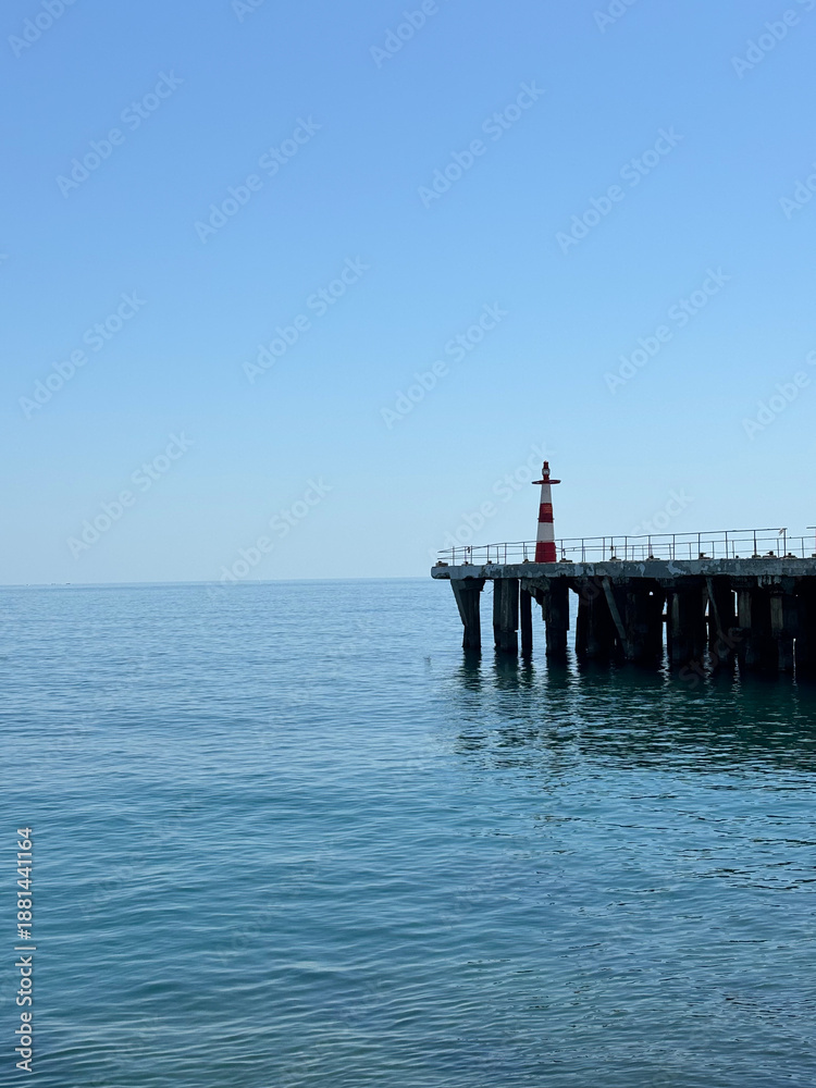 Fototapeta premium Old pier with lighthouse, Alushta, Crimea.