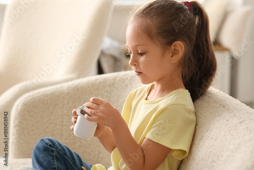 Cute little girl sitting on...