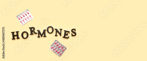 Word HORMONES with pills on...