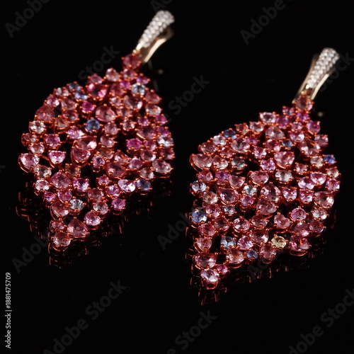 Photos Elegant leaf-shaped dangle earrings featuring soft pink gemstones in a graceful, nature-inspired design