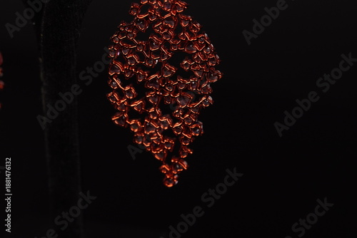 Slika na platnu Elegant leaf-shaped dangle earrings featuring soft pink gemstones in a graceful, nature-inspired design