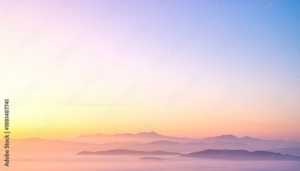 Obraz premium Mountains silhouetted at dawn beneath a pastel-colored sky
