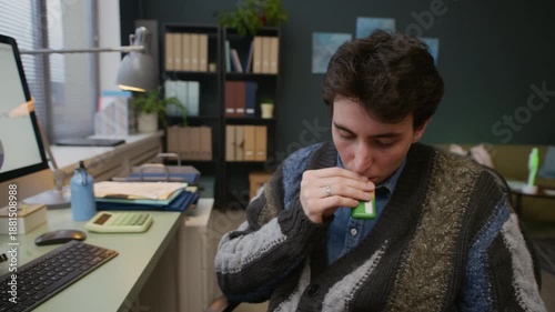 Zoom out shot of young male employee smoking vape at workplace while adult female manager reminding him about his work responsibilities in modern office