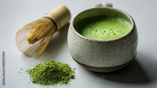 Traditional matcha tea presentation with bamboo whisk and powder