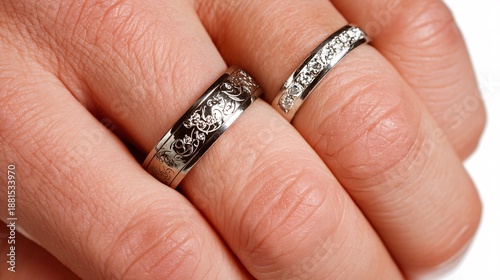 Elegant Silver Wedding Rings with Intricate Designs on Fingers