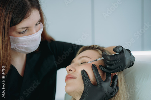  an aesthetic professional performing an injection procedure. Beauty treatment