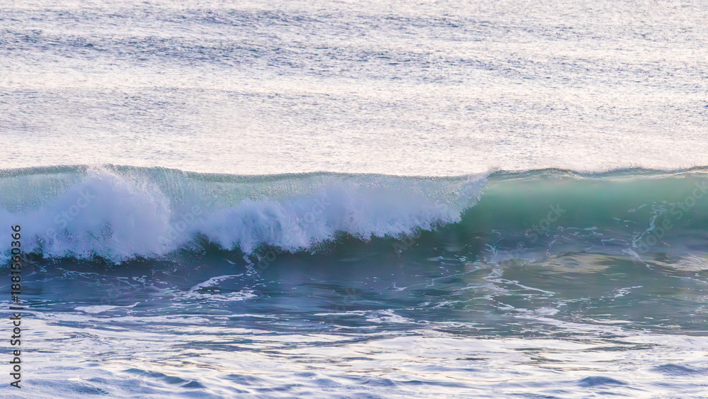 Fototapeta premium Translucent Green Breaking Wave at Sunrise