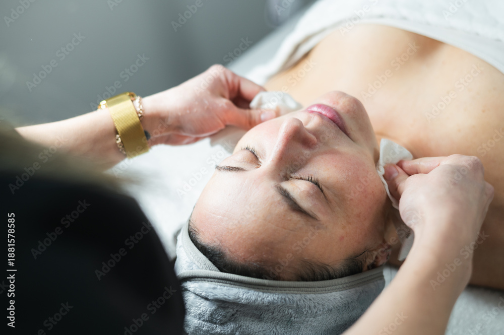 Fototapeta premium Woman receiving skin care facial treatment at spa