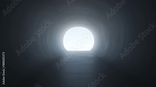 A dark tunnel stretches out with a bright light at the end in sight.