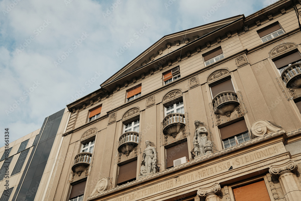 Obraz premium Historic building facade in Belgrade old town with sculptural details, balconies and classical ornaments, representing European cultural architecture and urban heritage.