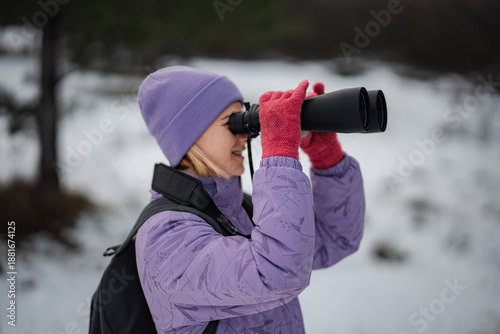Wallpaper Mural Woman using binoculars birdwatching in winter forest Torontodigital.ca