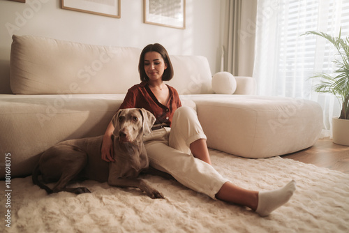 woman and dog in peaceful room, tranquil scene of woman and dog basking in gentle morning light at home