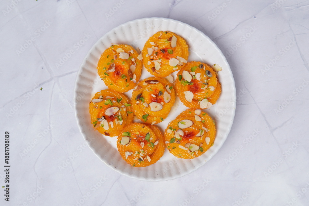 Φωτογραφία Paneer jalebi is a rich and indulgent Indian sweet made from fresh paneer, shaped into spirals, deep-fried, and soaked in fragrant sugar syrup