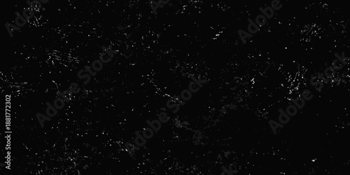 Abstract dark background with scattered white specks and texture