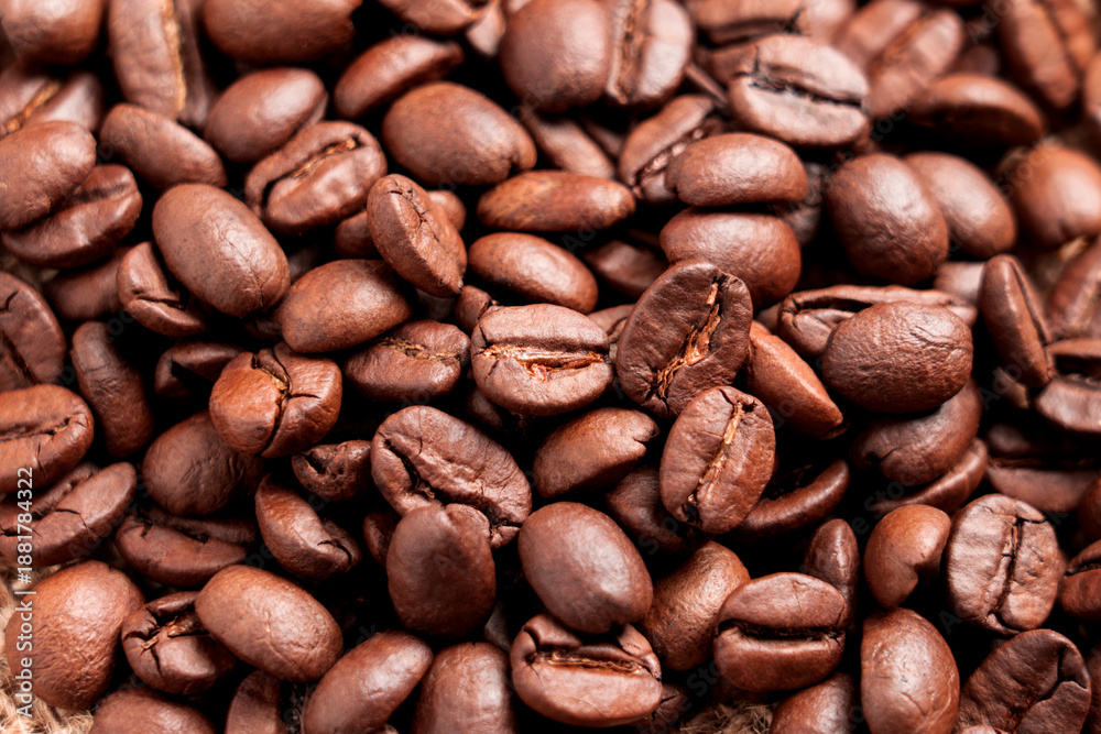 Fototapeta premium Roasted aromatic Arabica coffee beans. Close-up. An organic morning beverage ingredient.