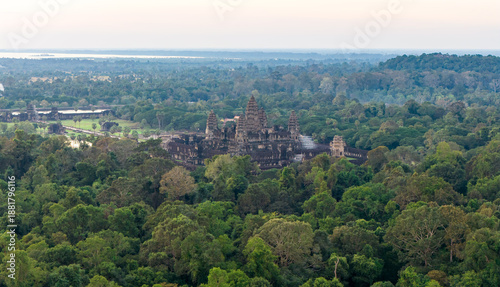 Angkor Wat temple complex aerial drone photo shows symmetrical Khmer towers, galleries and courtyards amid green lawns and jungle. Concept, quality image for editorial, tourism ads and destination use