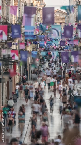 Wallpaper Mural Tourists and locals walking and shopping in Rue Sainte-Catherine timelapse, Bordeaux, France. The longest pedestrian street in the country. Atmosphere of urban life. Colorful flags decorate the street Torontodigital.ca