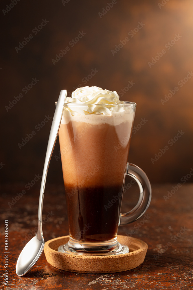 Fototapeta premium Hot chocolate with whipped cream in a glass mug.