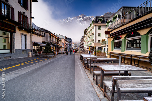 Streets with people in Alpine town Chamonix-Mont-Blanc, popular ski resort in France.