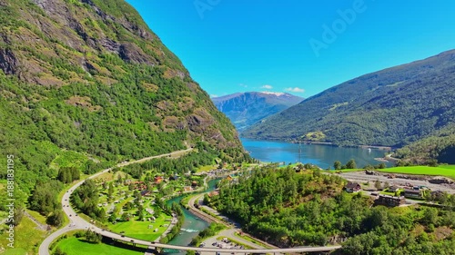 Flam Norway aerial drone skyline view of green valley, river, farms and village on sunny summer day