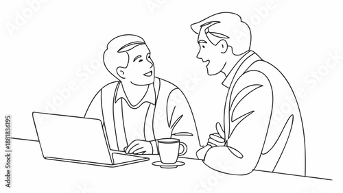 Two men in conversation at a table with a laptop and coffee cup
