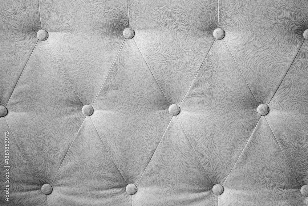 Obraz premium Elegant silver gray tufted textile background with decorative buttons forming a diamond pattern