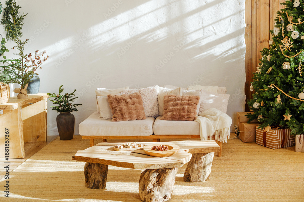 Fototapeta premium Cozy living room with Christmas tree and gifts next to couch, natural wood furniture