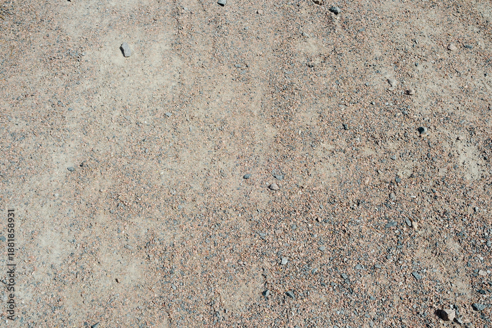 Fototapeta premium Dry gravel and sand ground texture with tiny pebbles and small stones detail close up