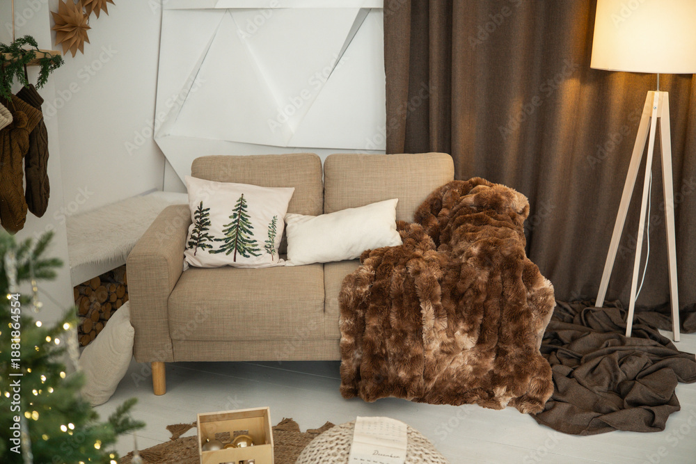 Fototapeta premium Cozy living room with sofa, plush throw, festive decor, and ambient lighting.