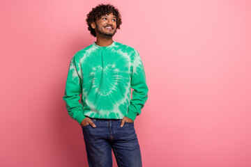 Young male model in green tie dye sweatshirt smiling against pink background fashion lifestyle advertising