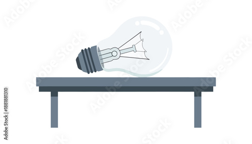 Light bulb resting horizontally on a simple gray table with a clear white background studio