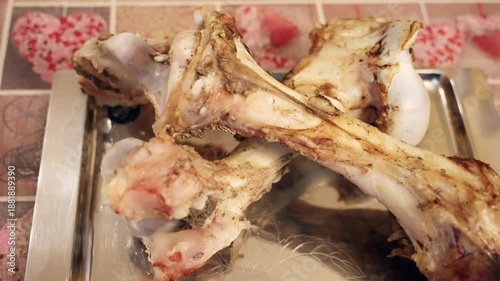 Large cooked beef bones on metal tray food waste or pet treats