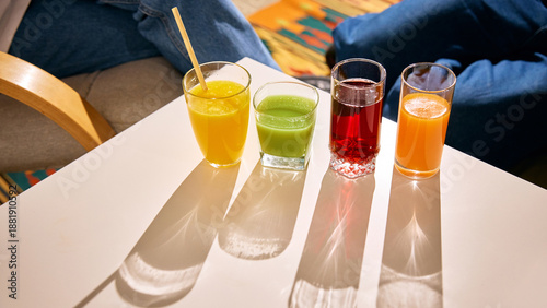Billede på lærred Assorted fresh juices in glasses on bright table with sunlight