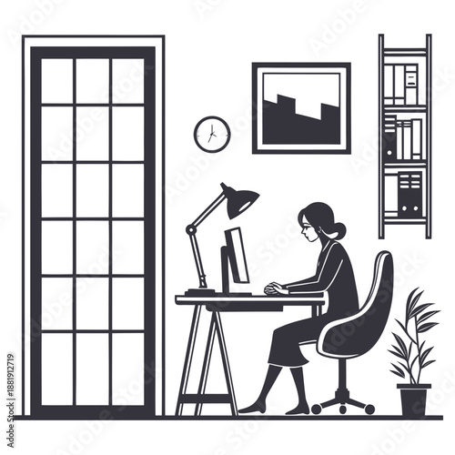 Woman sitting at desk working on computer in office cubicle space